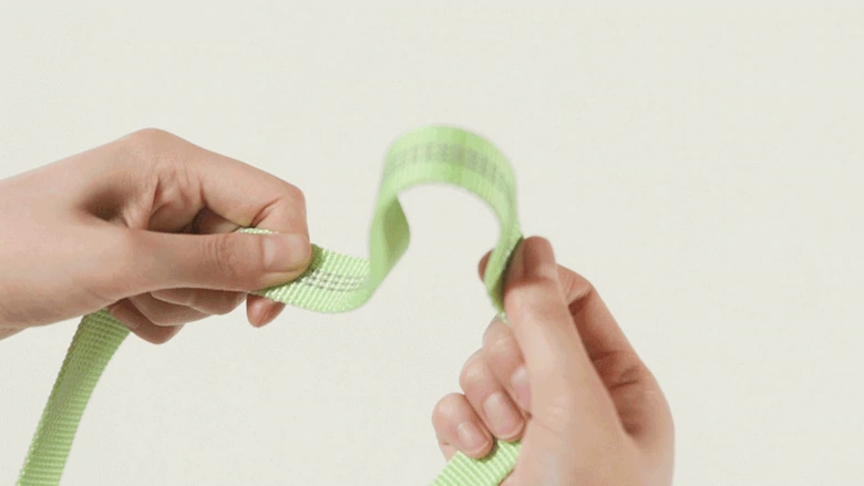 PPZ pet harness traction suit: close-up of webbing: hand showing surface shape